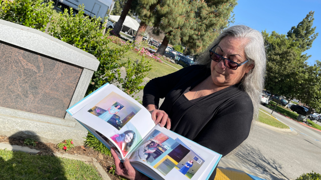 Delissa holding a photo book